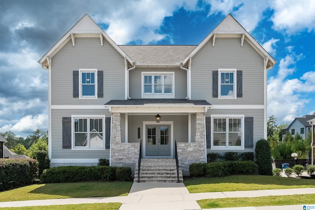 craftsman-style house with a front yard and a porch