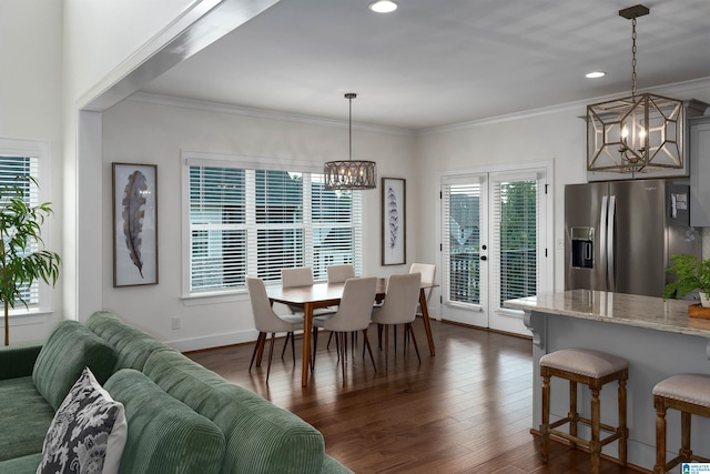 dining room featuring dark hardwood / wood-style flooring and a healthy amount of sunlight