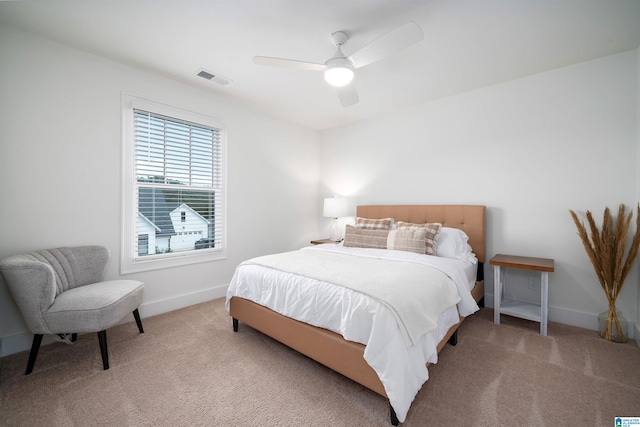 bedroom featuring ceiling fan and light carpet