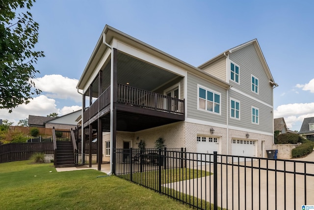 rear view of house with a garage and a lawn