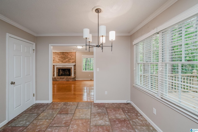 3424 Oakdale Dr, Vestavia Hills, AL 35223 - unfurnished dining area with a notable chandelier, ornamental molding, stone tile floors, a fireplace, and baseboards