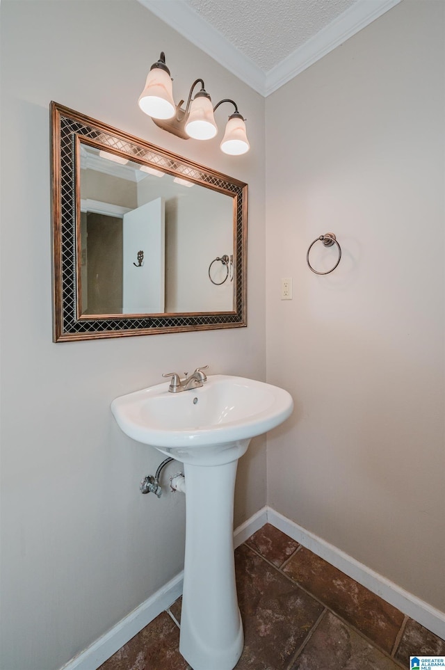 3424 Oakdale Dr, Vestavia Hills, AL 35223 - bathroom featuring a sink, a textured ceiling, baseboards, and ornamental molding
