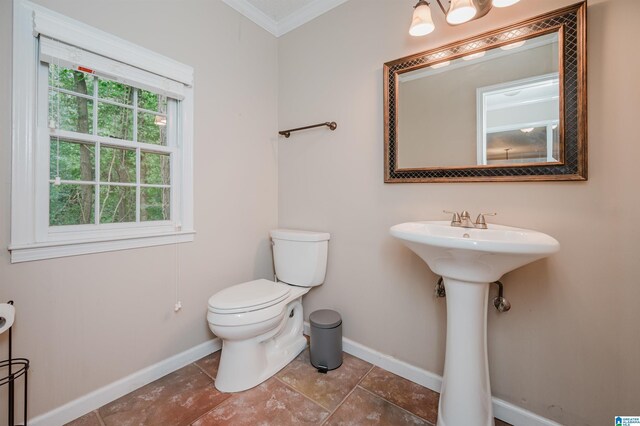 bathroom featuring tile patterned floors, toilet, and ornamental molding