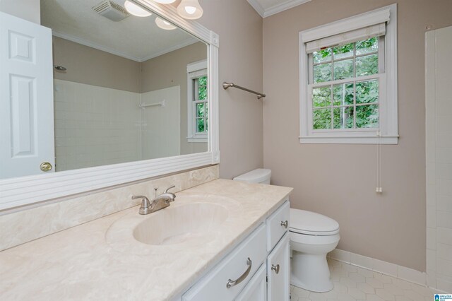 bathroom with toilet, a wealth of natural light, crown molding, and vanity