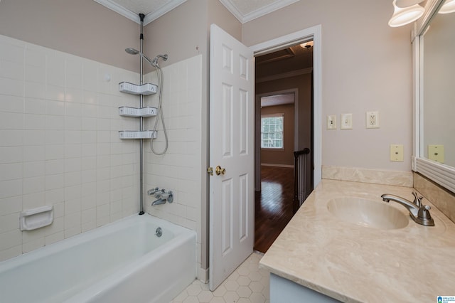 bathroom with crown molding, vanity, tiled shower / bath, and wood-type flooring