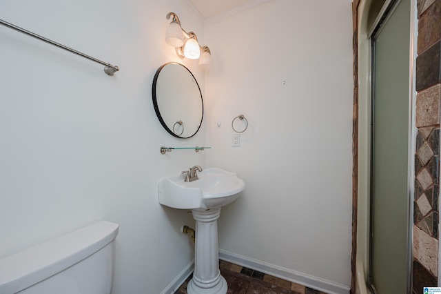 bathroom with an enclosed shower, toilet, and crown molding