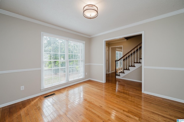 3424 Oakdale Dr, Vestavia Hills, AL 35223 - unfurnished room with ornamental molding, baseboards, visible vents, and light wood-type flooring