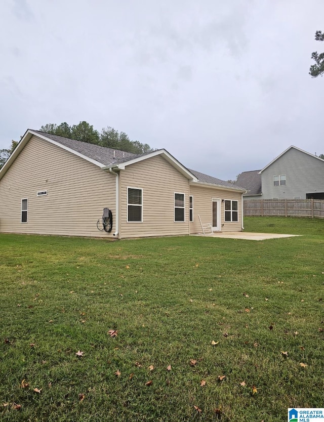 rear view of property featuring a yard