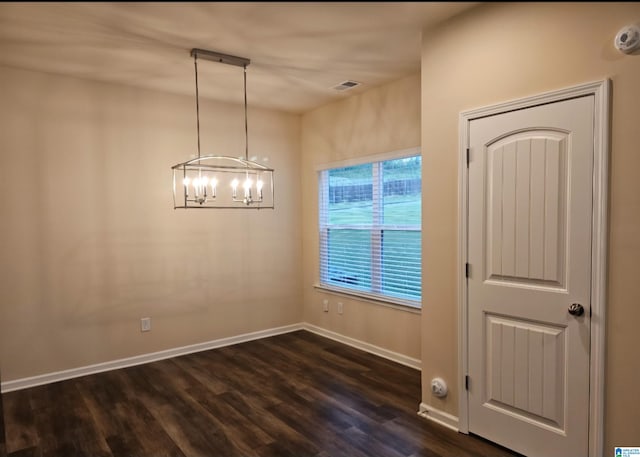 interior space with an inviting chandelier and dark hardwood / wood-style flooring