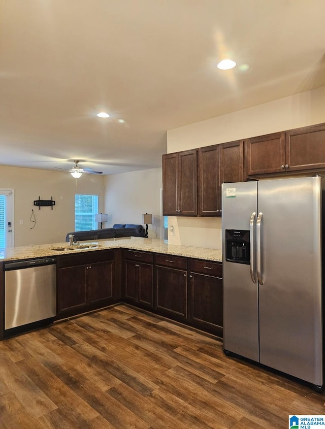 kitchen featuring stainless steel appliances, dark brown cabinets, ceiling fan, dark hardwood / wood-style floors, and sink