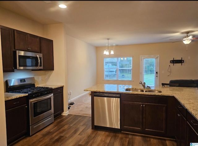 kitchen with dark hardwood / wood-style floors, sink, hanging light fixtures, appliances with stainless steel finishes, and ceiling fan