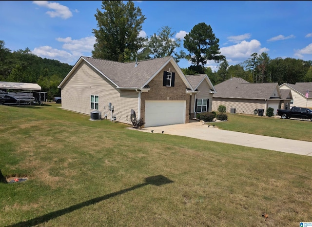 view of front of home with cooling unit, a garage, and a front lawn