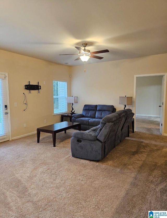 carpeted living room with ceiling fan