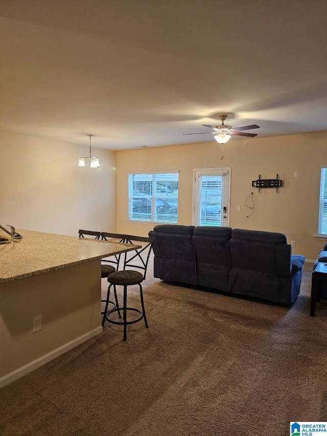 living room with dark carpet and ceiling fan