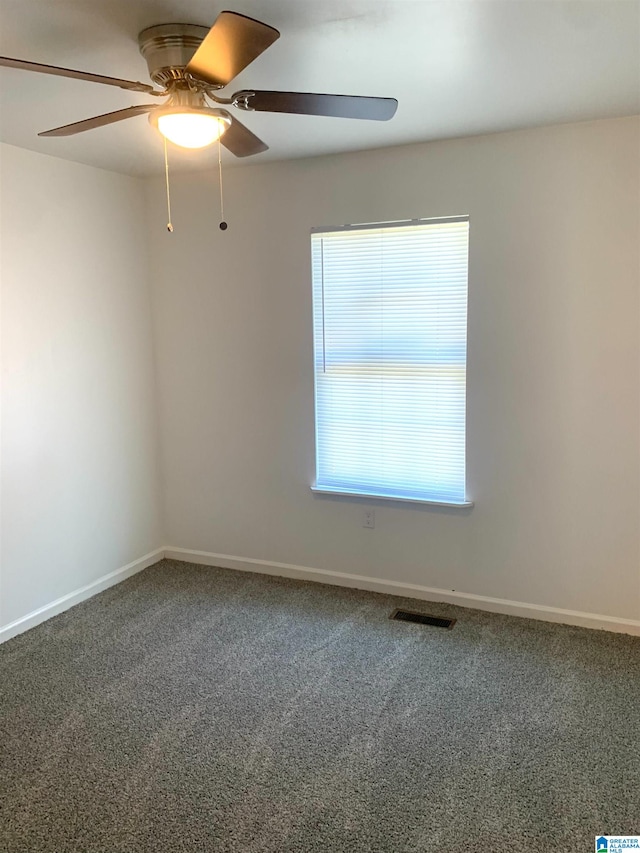 carpeted spare room with ceiling fan