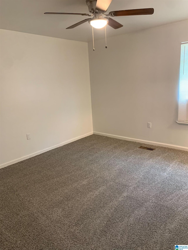 unfurnished room with ceiling fan and carpet