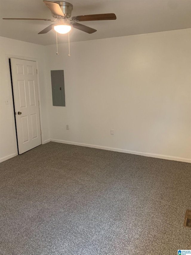 carpeted empty room featuring electric panel and ceiling fan