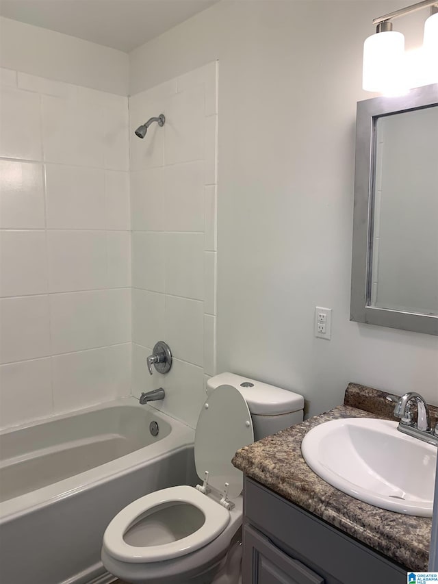 full bathroom featuring toilet, tiled shower / bath combo, and vanity