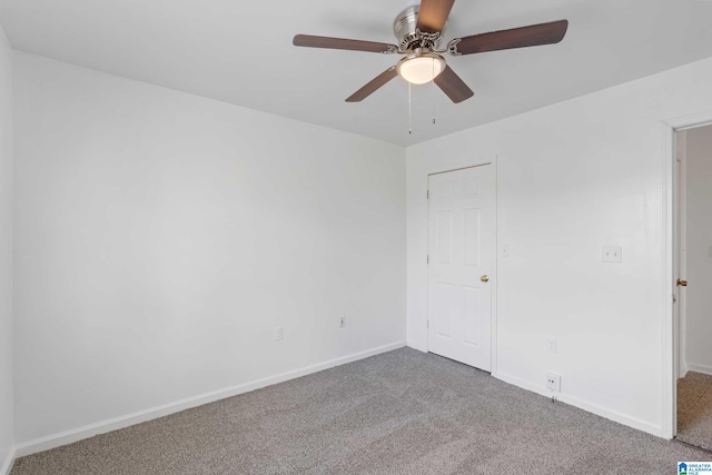 carpeted empty room featuring ceiling fan