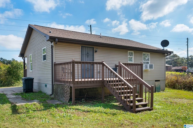 rear view of house featuring cooling unit, a lawn, and a wooden deck