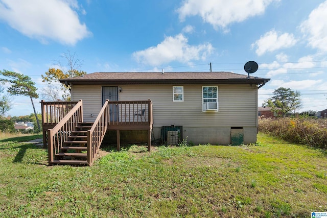 rear view of house featuring a wooden deck, cooling unit, and a yard