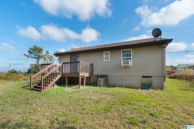 rear view of property with a wooden deck, cooling unit, and a lawn