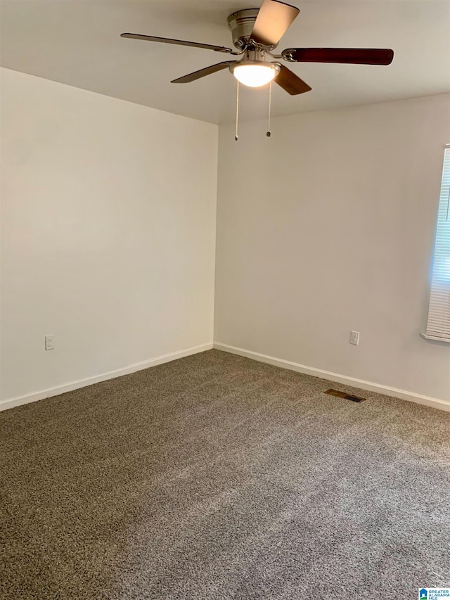 spare room with carpet flooring and ceiling fan