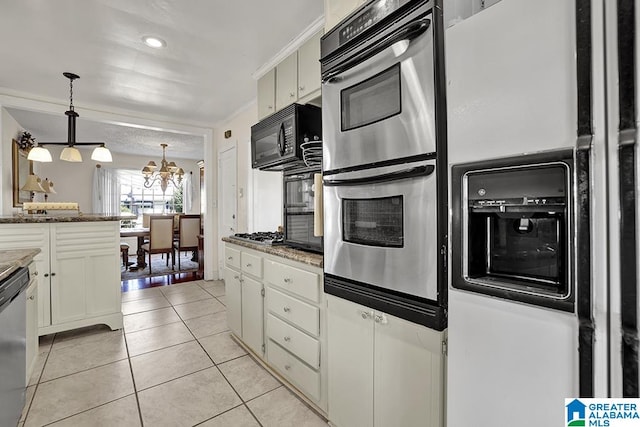 kitchen featuring light stone countertops, pendant lighting, a notable chandelier, light tile patterned floors, and appliances with stainless steel finishes