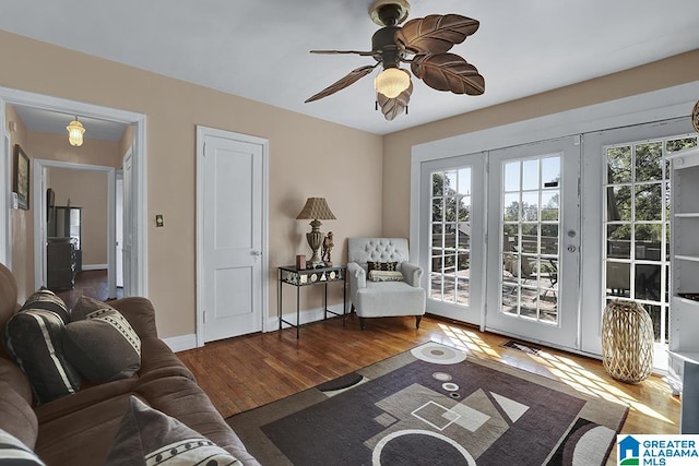 living room featuring hardwood / wood-style floors, ceiling fan, and french doors