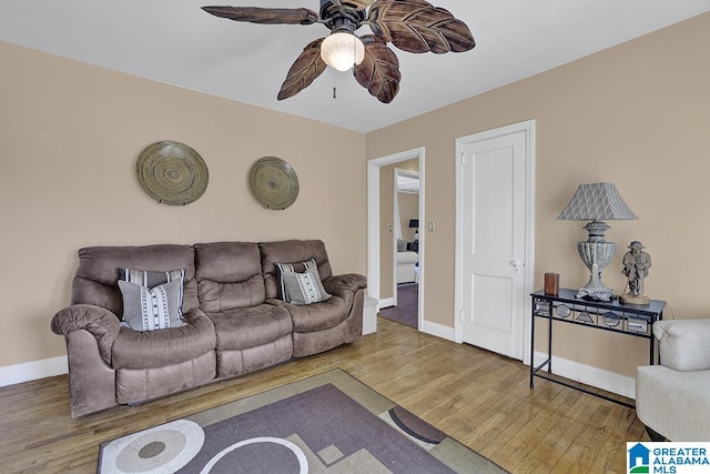 living room featuring ceiling fan and hardwood / wood-style flooring