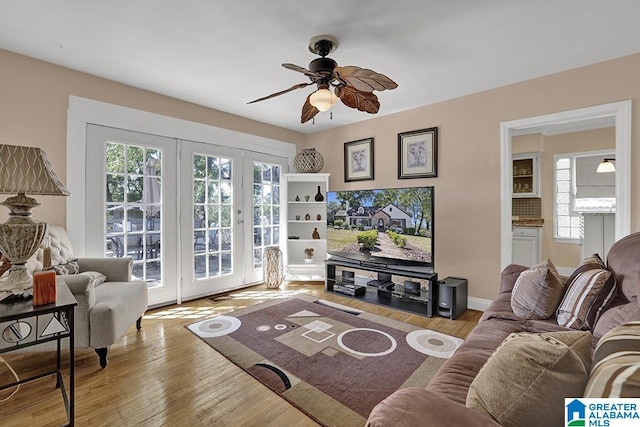 living room featuring ceiling fan and light hardwood / wood-style floors