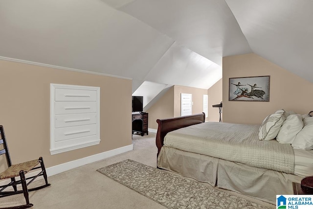 carpeted bedroom with lofted ceiling