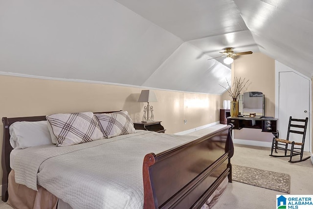 carpeted bedroom with ceiling fan and vaulted ceiling