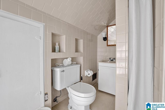 949 44th St, Birmingham, AL 35208 - bathroom with tile patterned floors, toilet, a shower with shower curtain, and tile walls