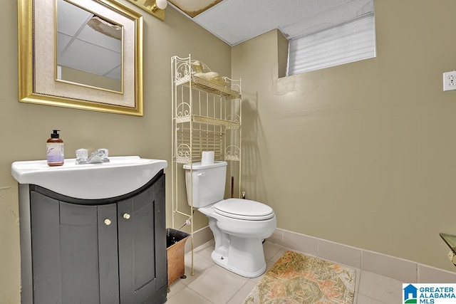 bathroom featuring tile patterned floors, toilet, and vanity