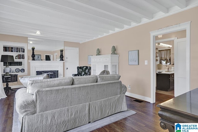 living room with dark hardwood / wood-style flooring and beam ceiling