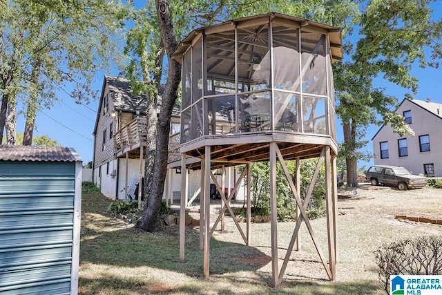 rear view of house featuring a sunroom