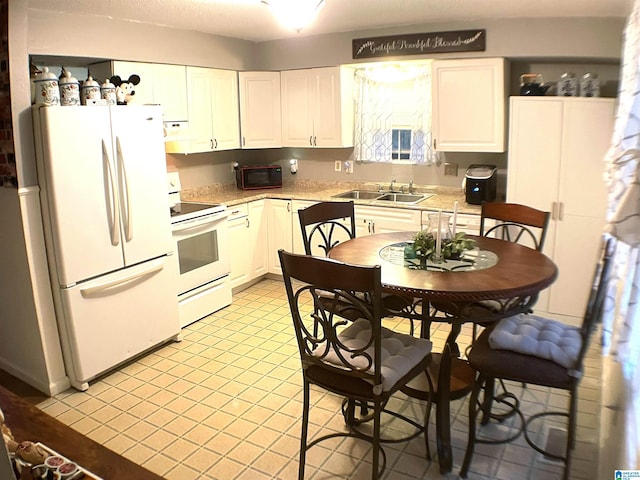 kitchen with white cabinetry, sink, extractor fan, and white appliances