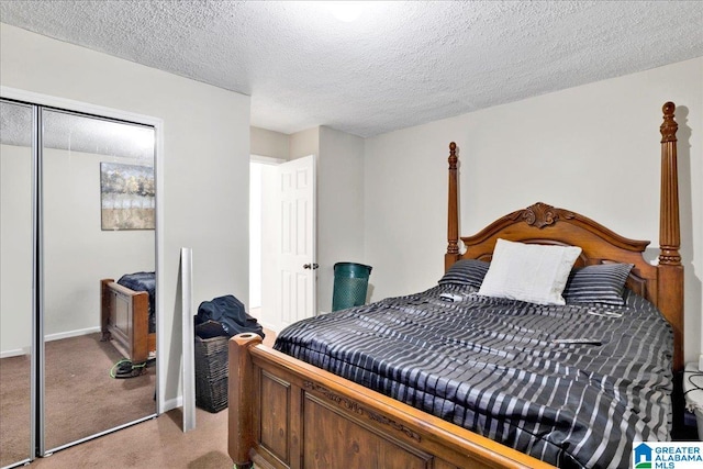 carpeted bedroom with a textured ceiling and a closet