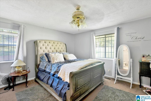 bedroom featuring carpet, a textured ceiling, and multiple windows