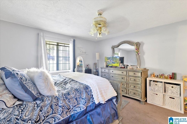 carpeted bedroom featuring a textured ceiling and ceiling fan