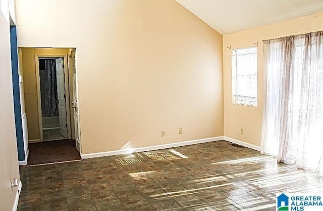 spare room featuring vaulted ceiling