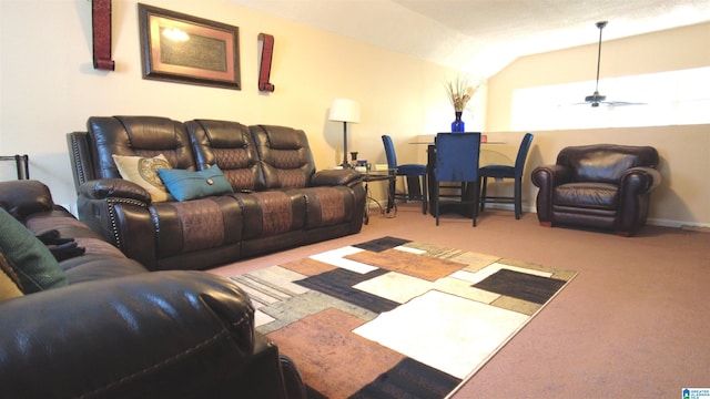 living room with ceiling fan, lofted ceiling, and light carpet