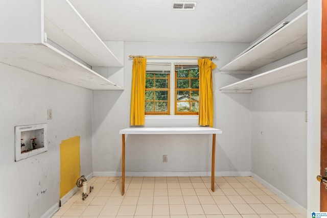 washroom with washer hookup and a textured ceiling