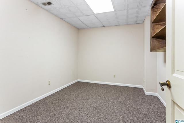 carpeted spare room featuring a paneled ceiling