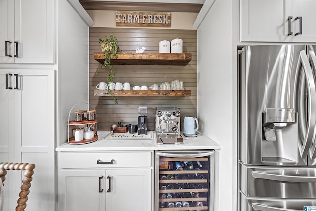 bar featuring wine cooler, white cabinets, and stainless steel refrigerator with ice dispenser