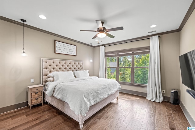 bedroom featuring ceiling fan, ornamental molding, and dark hardwood / wood-style floors