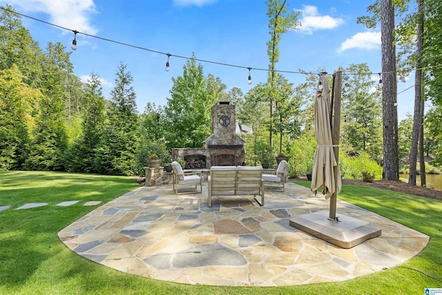 view of patio / terrace featuring an outdoor stone fireplace