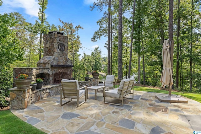 view of patio / terrace featuring an outdoor stone fireplace