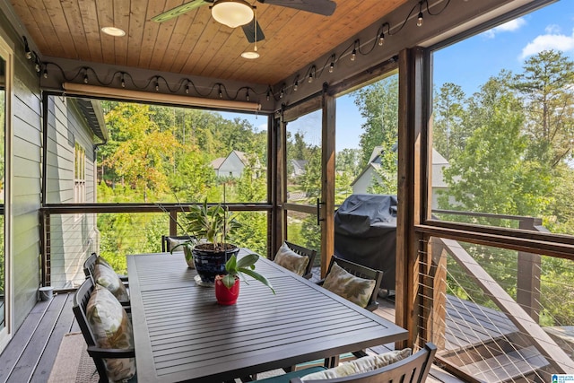 sunroom / solarium with wood ceiling and ceiling fan